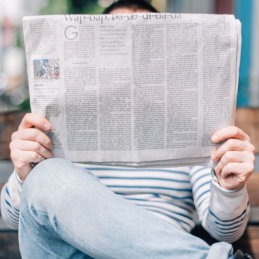 Man sitting reading a newspaper