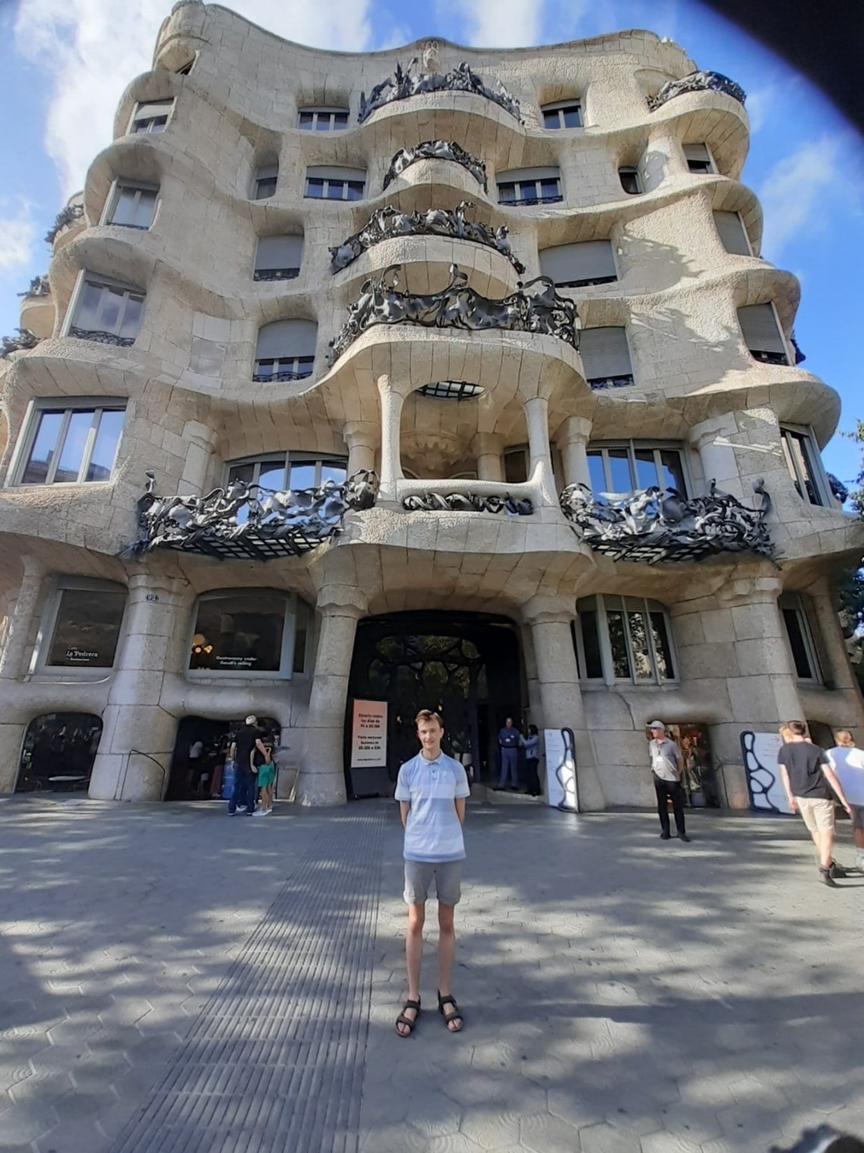 Adam, a student at Essex on a Summer abroad experience in Barcelona. Adam is standing outside a building called Casa Mila