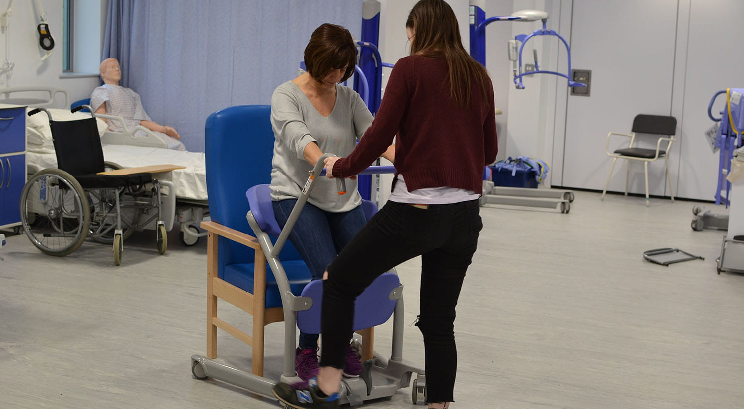 Occupational Therapy students using a sit to stand aid