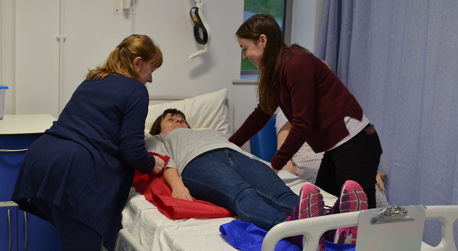 Occupational Therapy students practising using sliding sheets in our simulation ward