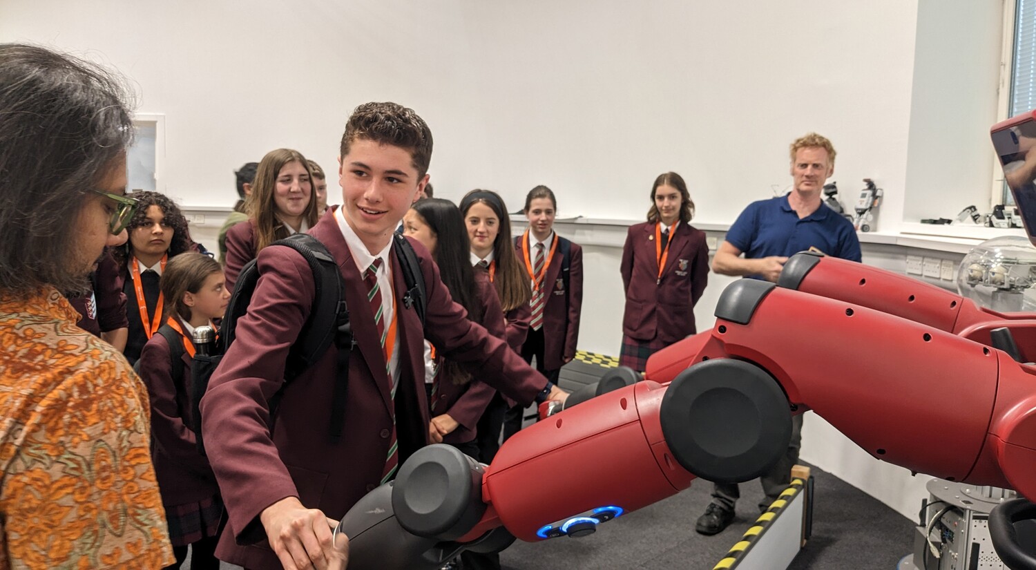 A student shakes hands with a robot