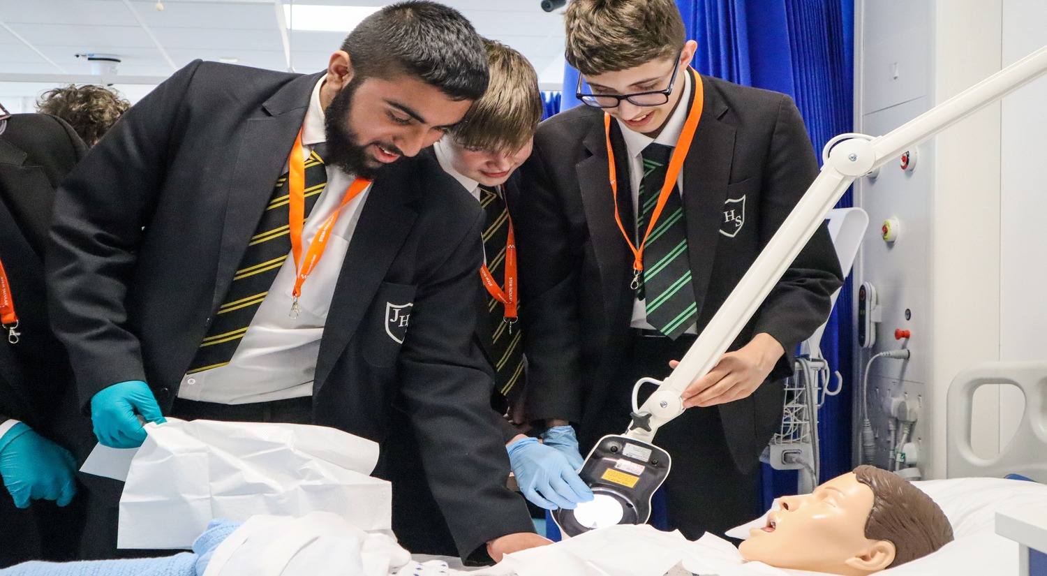 Youngsters examine a mock patient 