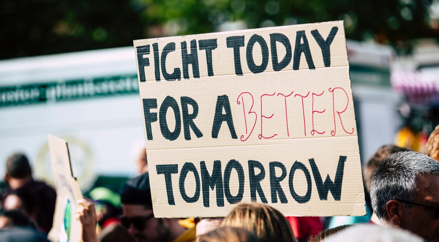Person holding fight today for a better tomorrow sign