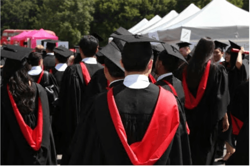 Graduates in their robes facing backwards