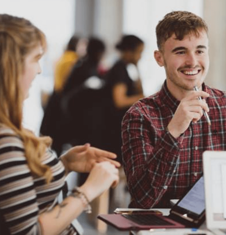 Student smiling at desk