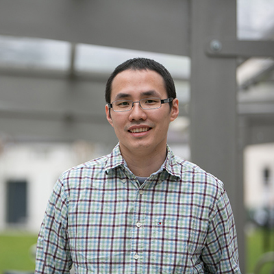 Caleb Kwong standing outside Essex Business School Southend Campus