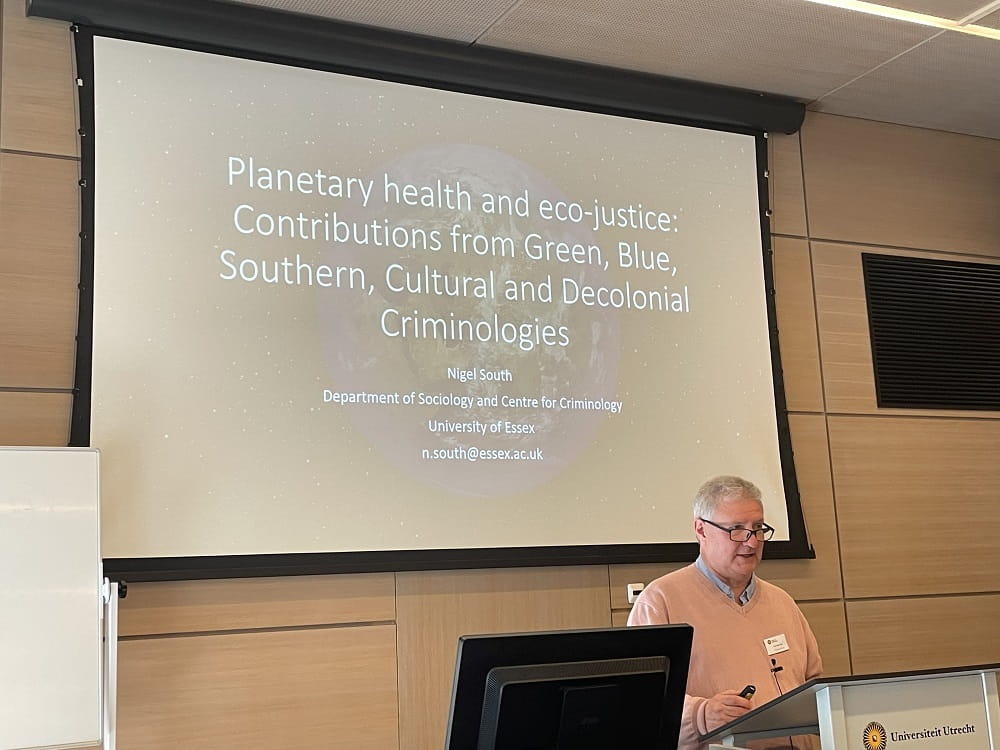 Photo of Professor NIgel South in Utrecht giving a presentation on planetary health and eco-justice