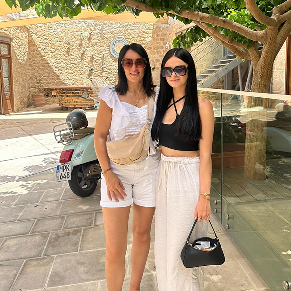 Mother and daughter, Melanie and Maddie are stood together smiling at the camera