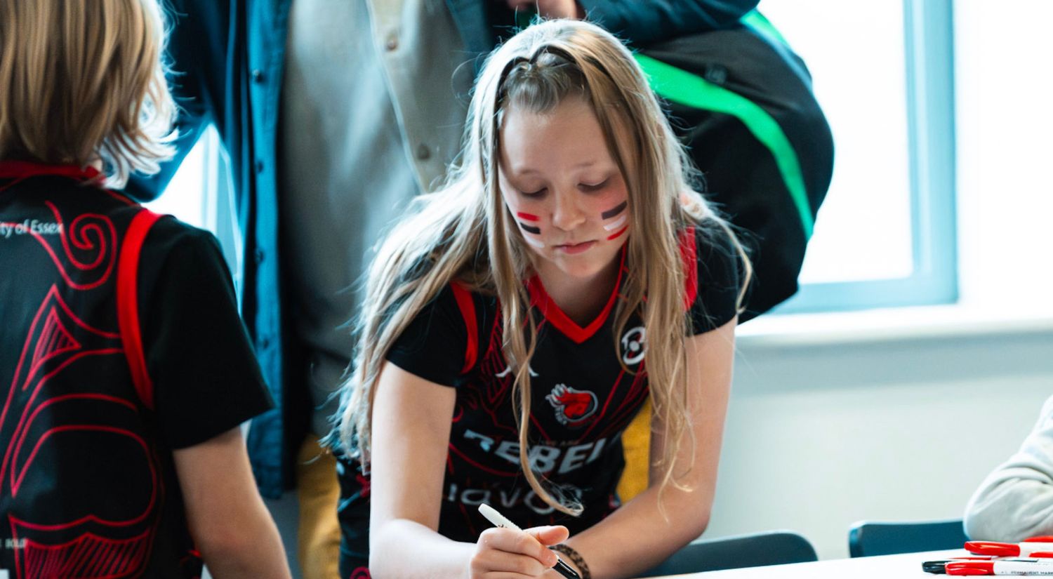 A young fan making a sign