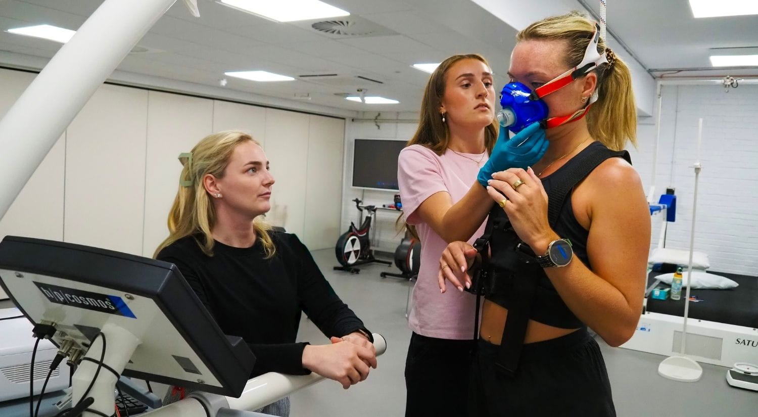 Emily Finch and Niamh Cameron fit a mask to Imo ahead of a Vo2 max test