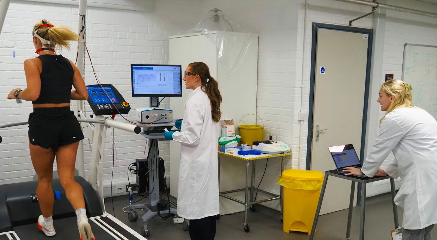 Researchers Emily Finch and Niamh Cameron test endurance star Imo Boddy