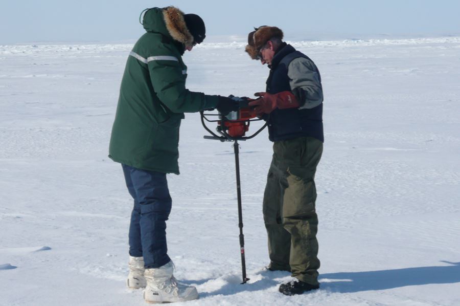 Professor Graham Underwood with Canadian field worker Duane Jordan drilling into the ice.