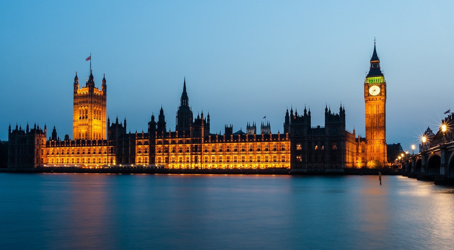 A night time scene of the Houses of Parliament in London.