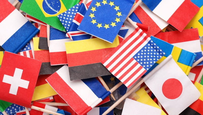 Lots of small paper flags on cocktail sticks from different countries.