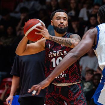Rebels Men's Basketball Player holding ball 