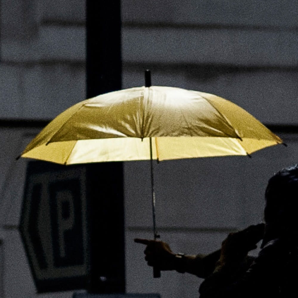 Yellow umbrella on black and white background