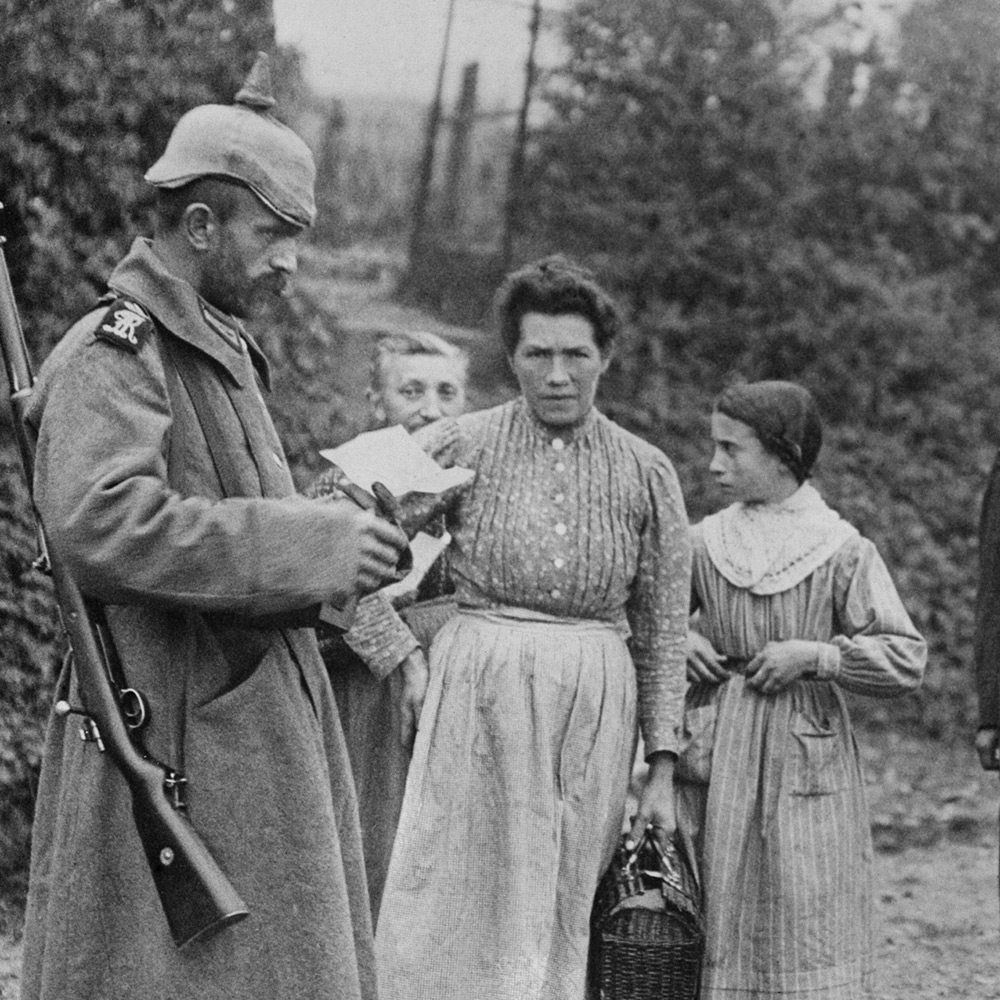 German soldier inspects documents of women in occupied France, First World War