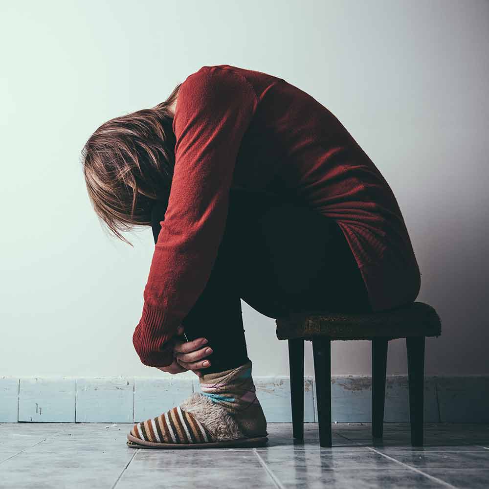 Woman sitting looking forlorn 