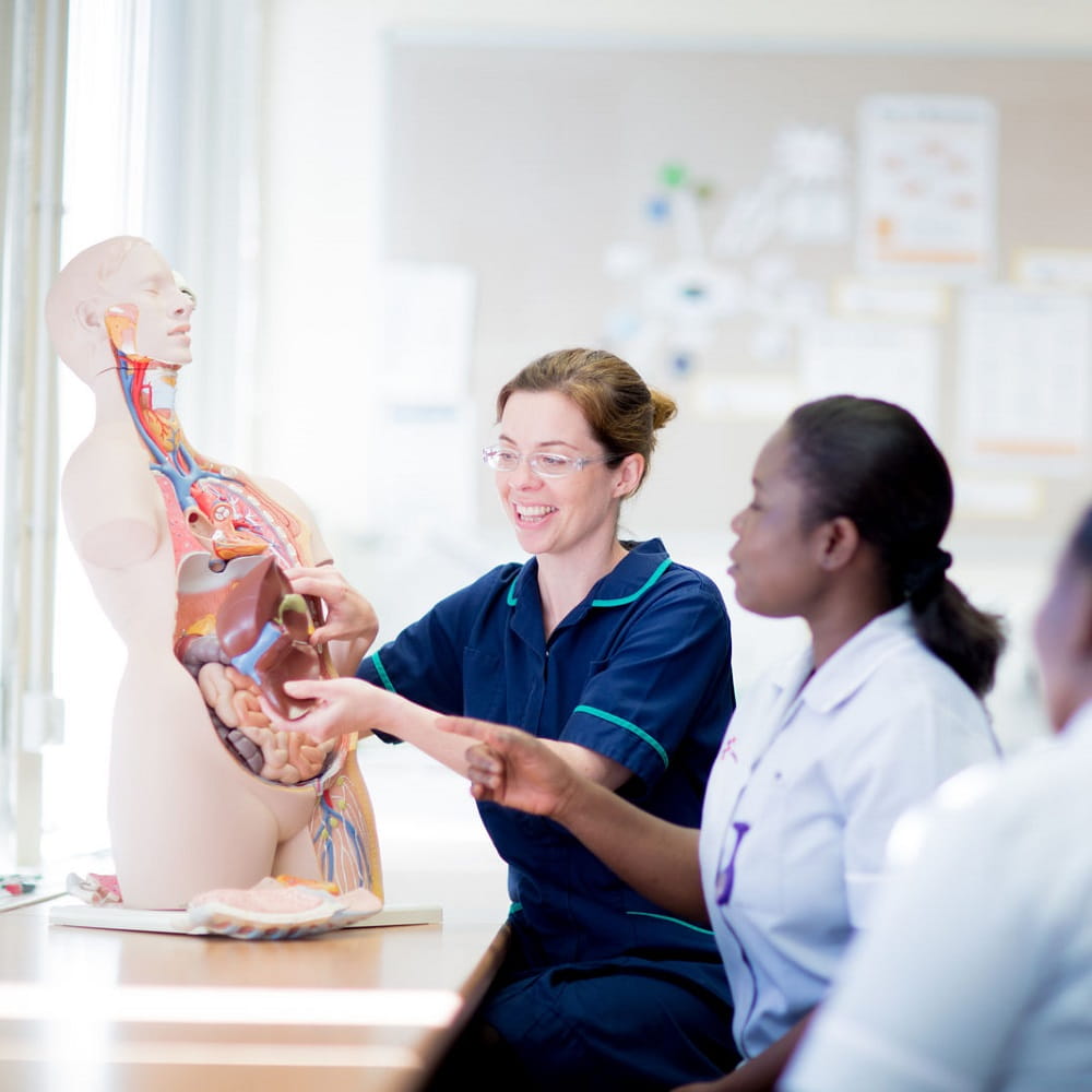 nursing students with mannequin