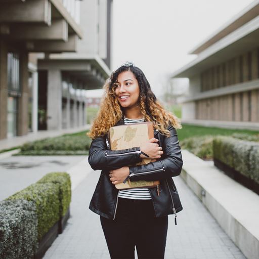 Image of a female student holding a laptop