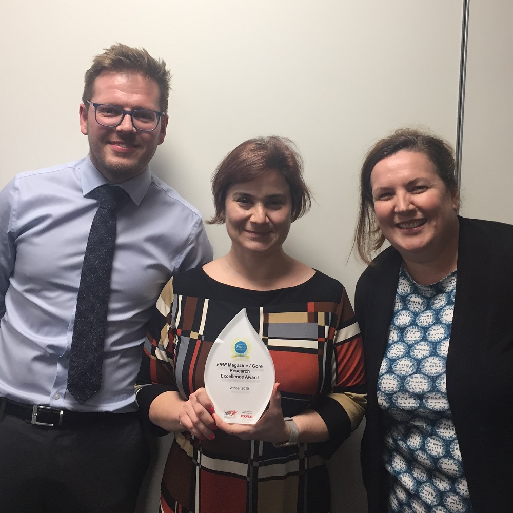 Team members pick up an award for a fire safety initiative