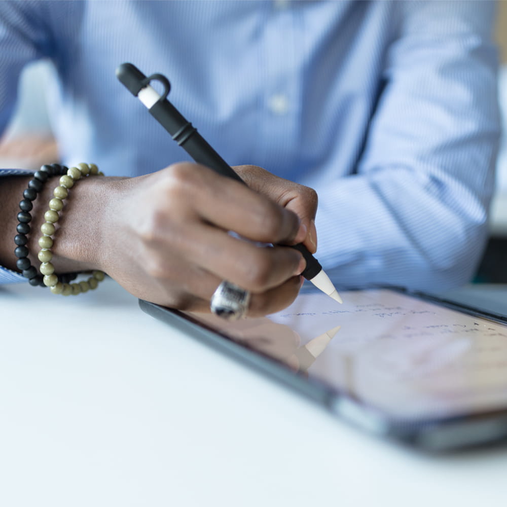 close up of mans hands in smart shirt with pen and  ipad