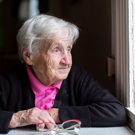 Old woman looking out of window