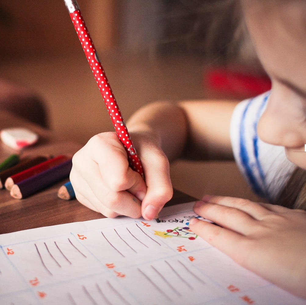 close up of girl writing