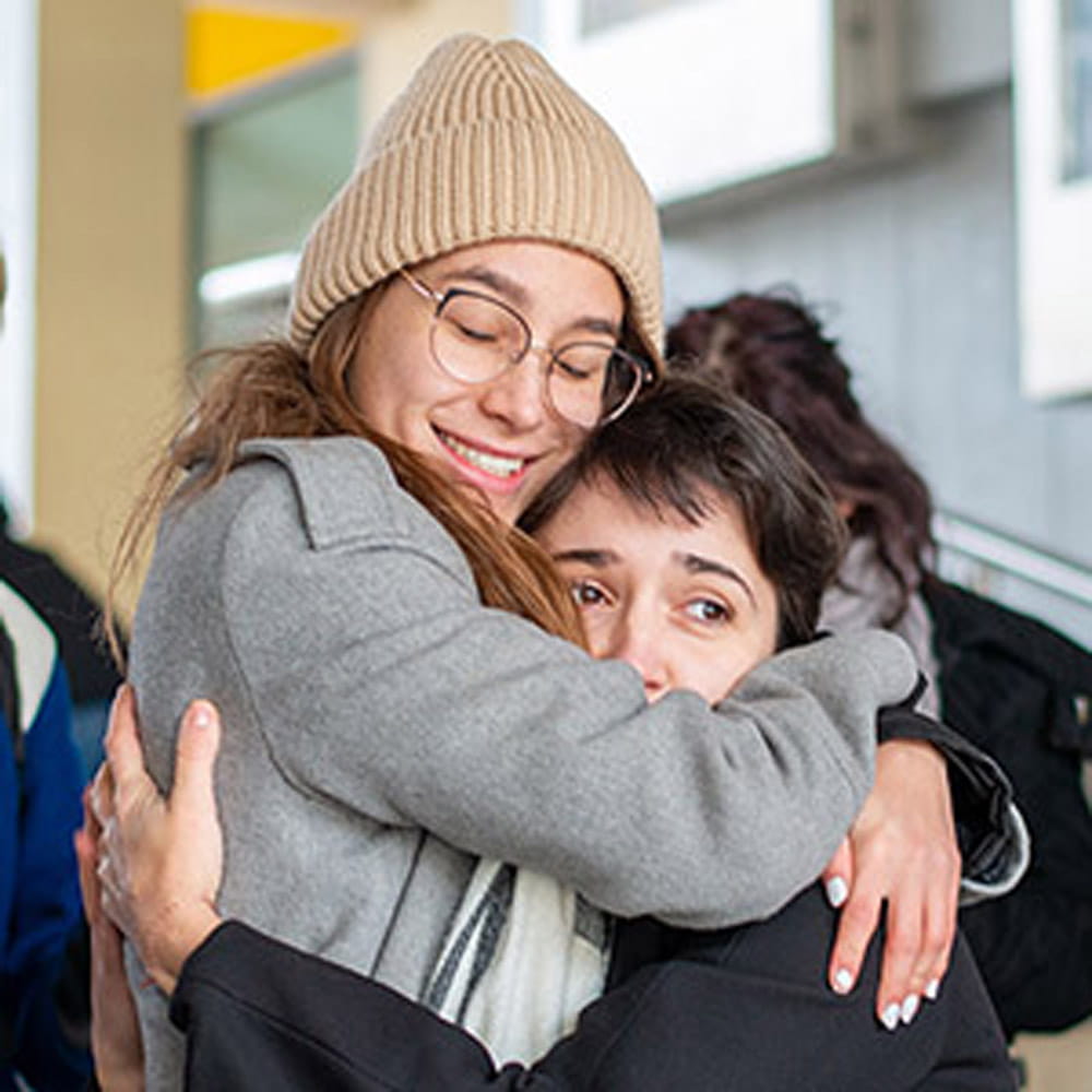 students hugging