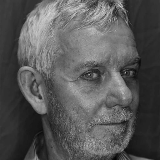 Mick Ekers, photographed in black and white, with grey hair