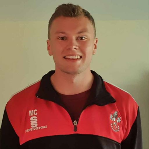 Miles Clayton, smiling and wearing a red sports top