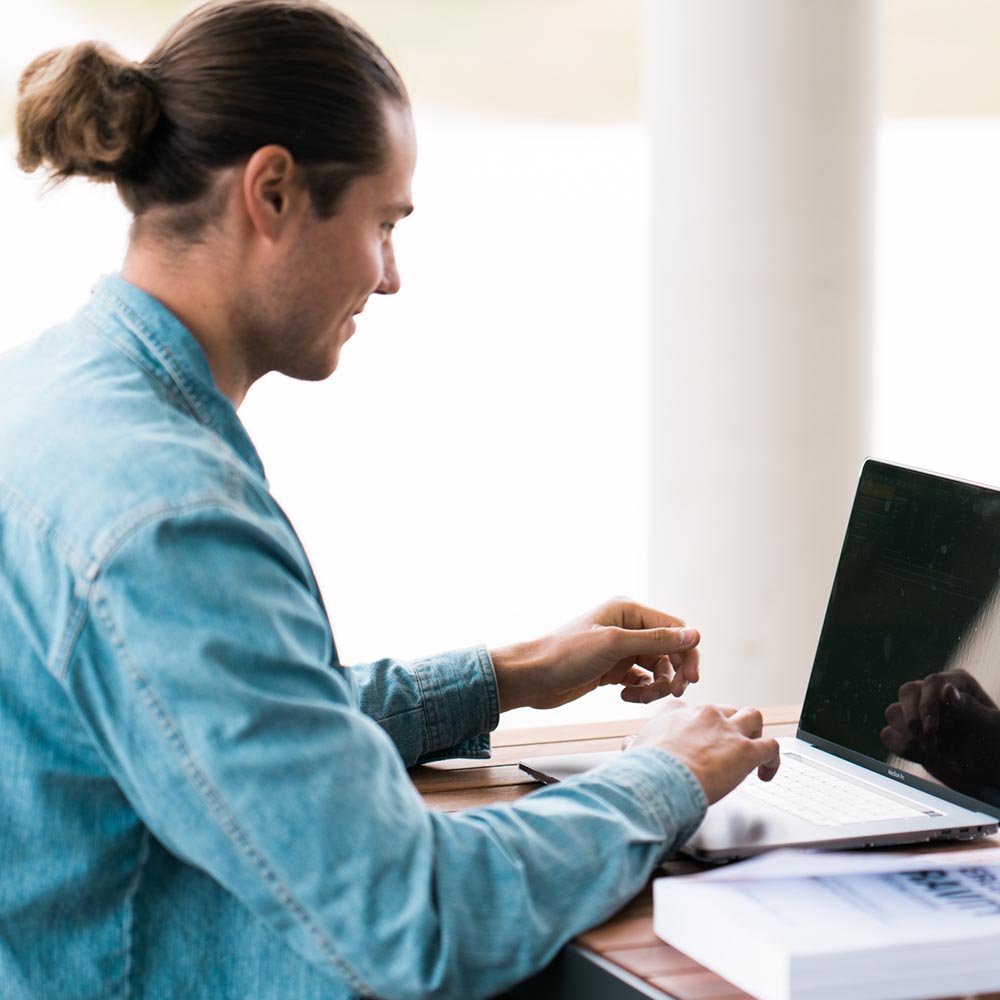 student on laptop sitting outside