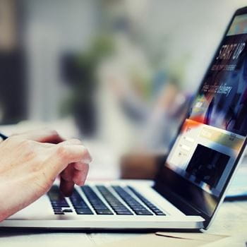 A person typing on a laptop.