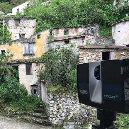 A view of the old town of Senerchia with a film camera in the foreground