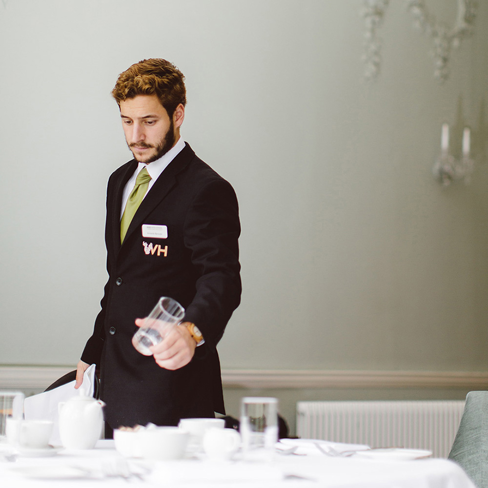 A student completes some work in the hotel dining room
