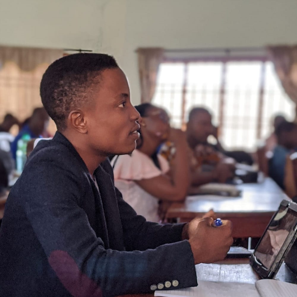 student with tablet looking forward in classroom