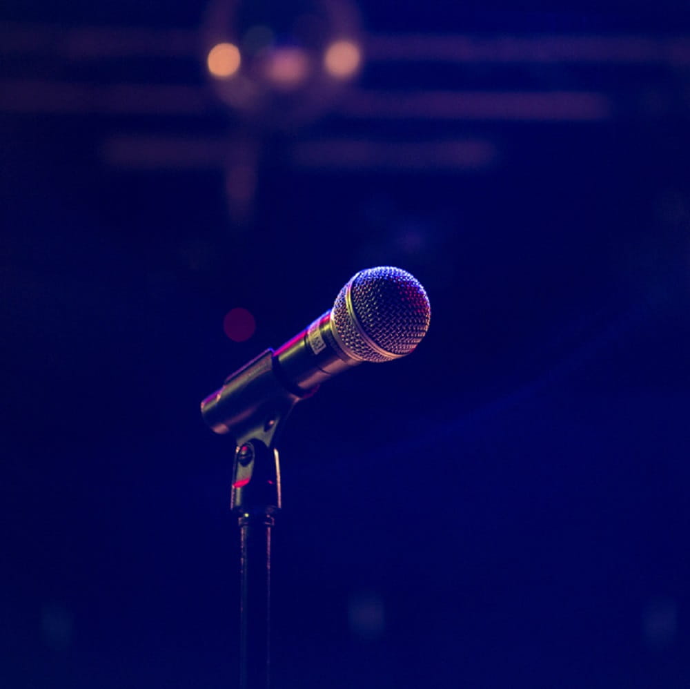 microphone siloutted against empty stage