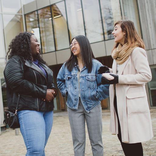Three students meeting outside Essex Business School