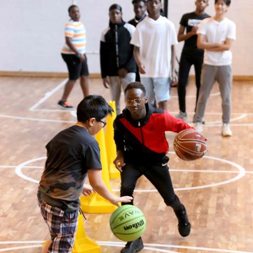 Two young boys playing basketball