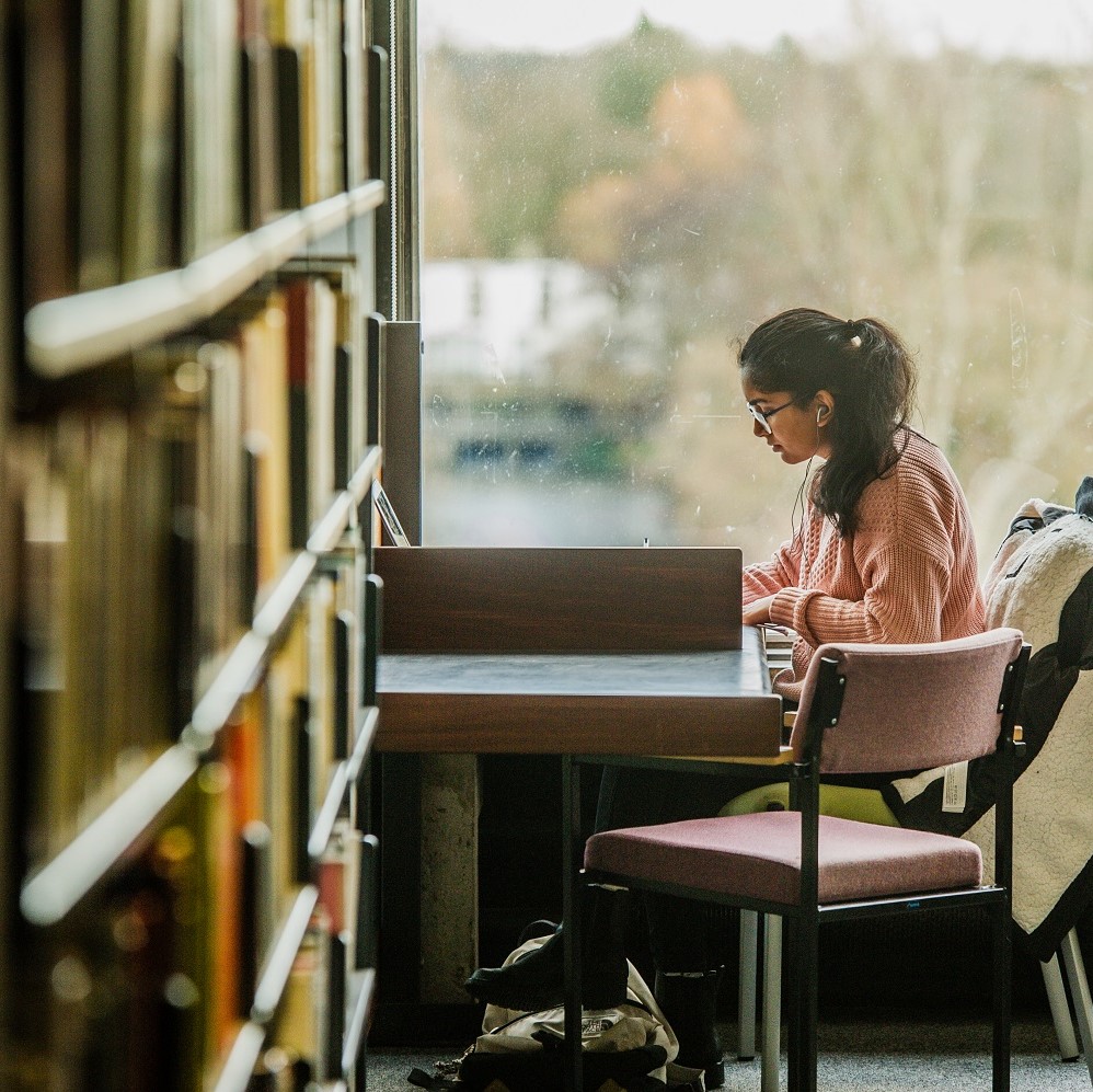 student studying in library