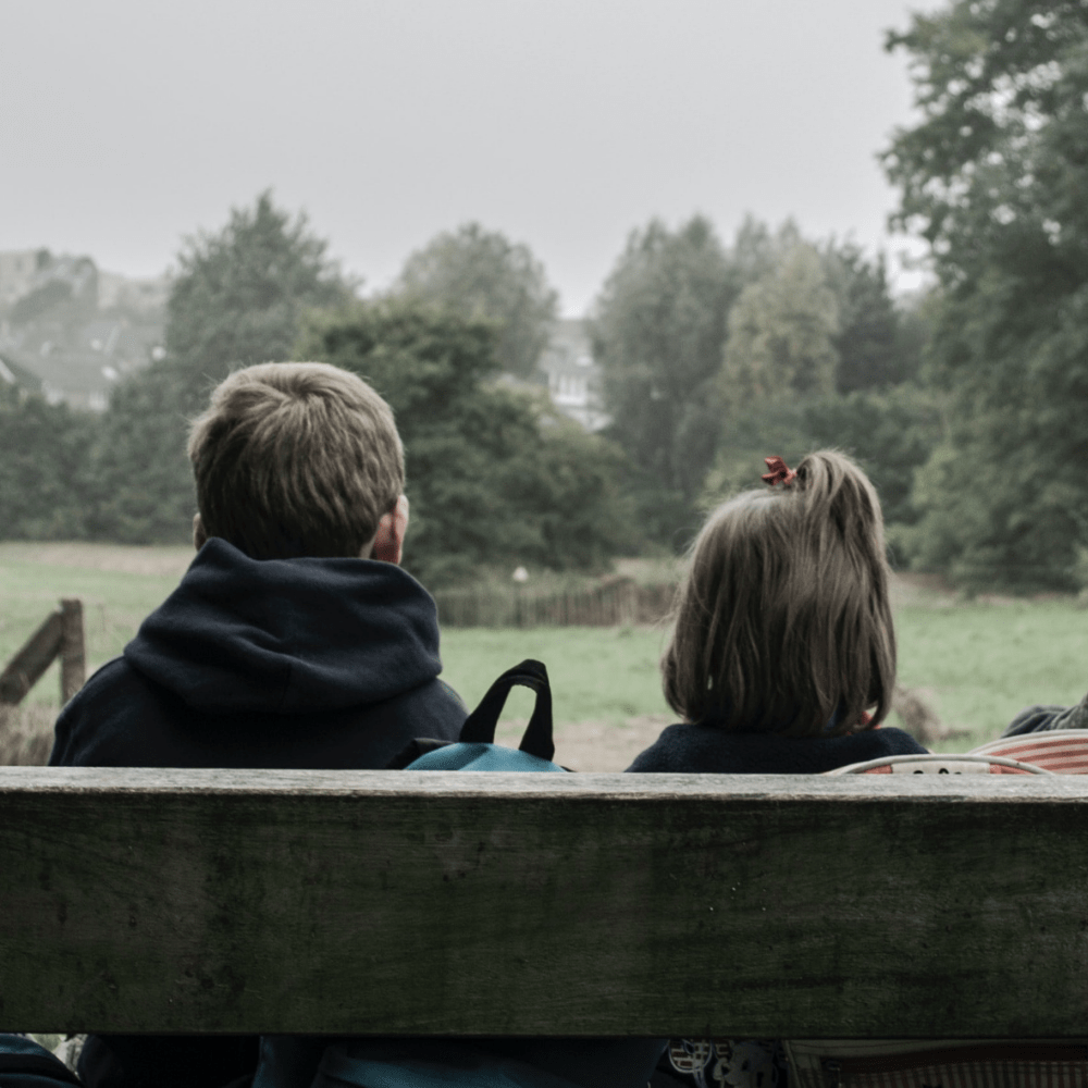 children sat on a park bench