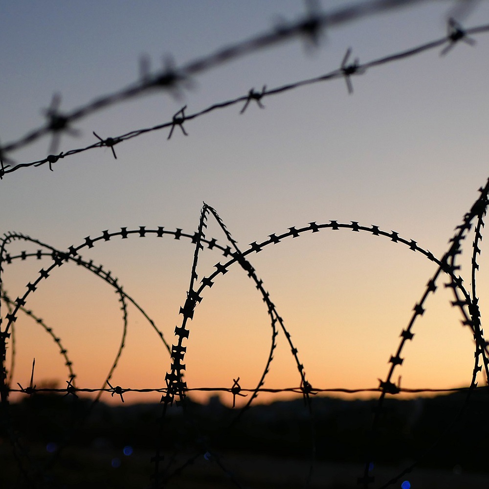 Barbed Wire with sunset in distance