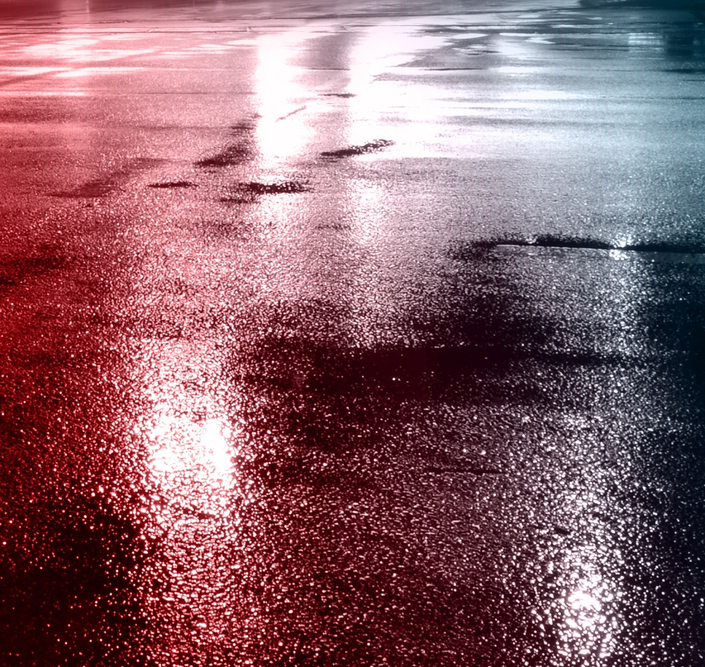 Red Police car lights reflected on wet ground
