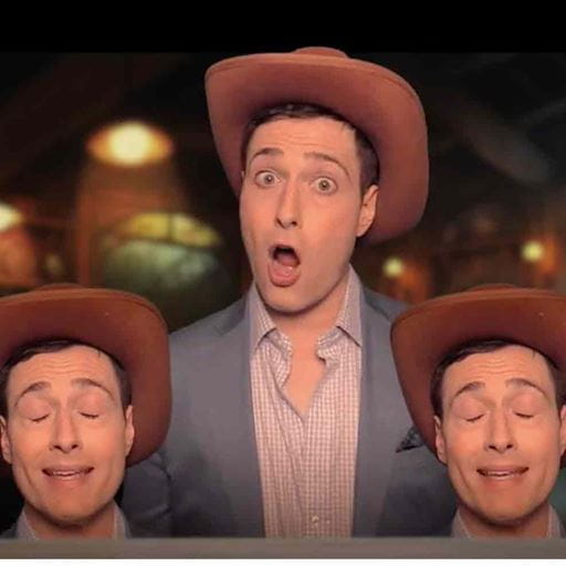 A still from a satirical film by Randy Rainbow featuring a man, wearing a Stetson cowboy hat seemingly singing