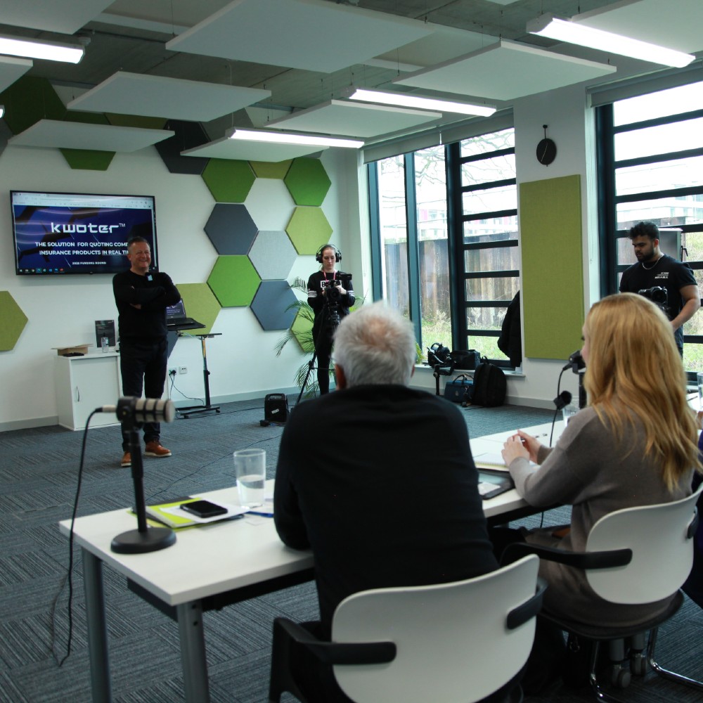 The panel listen to a pitch at the event
