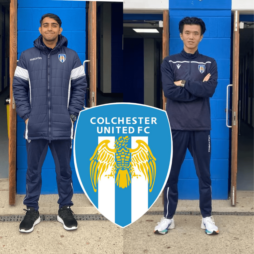 photo of two men standing infront of blue doors at Colchester United 