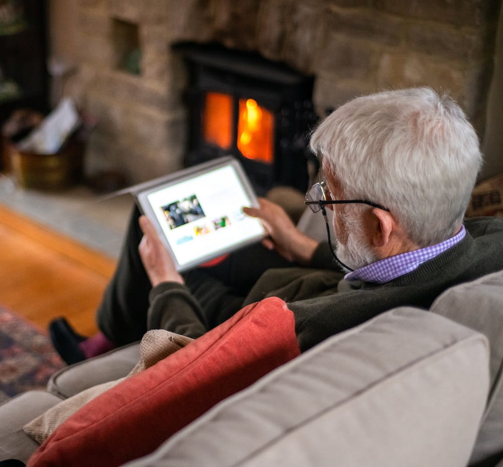 Man on sofa using iPad