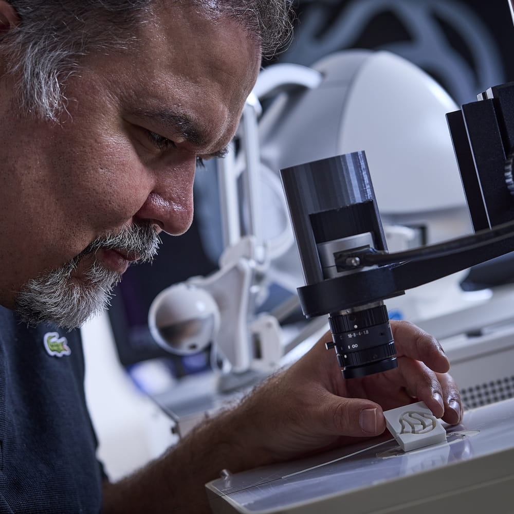 Dr Ali Hoshiar looking at microrobot though a microscrope