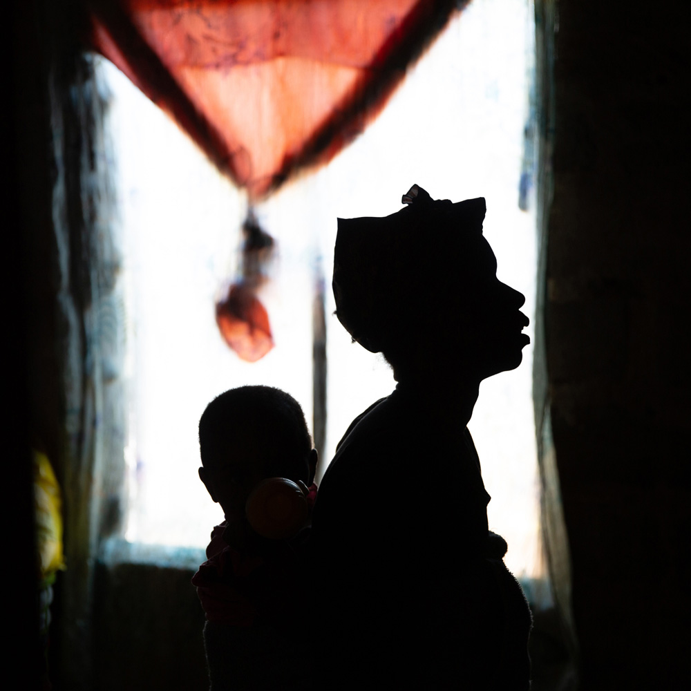 Woman carrying child on her back