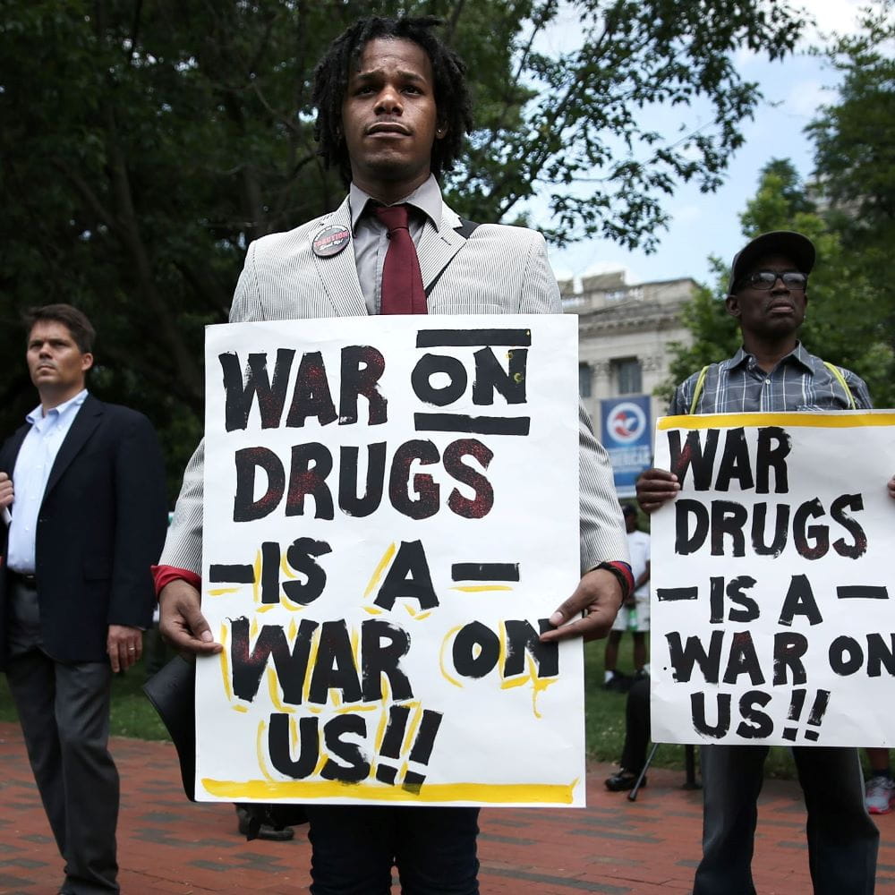 Men in the Phillippines protesting - the boards they are holding read War on Drugs is a War on Us!!